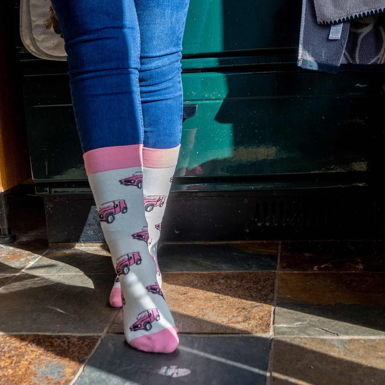 Pink land rover crew socks. These cosy socks offer a bright and elegant pink land rover design on a cream background and matching pink top, heel and toe.
