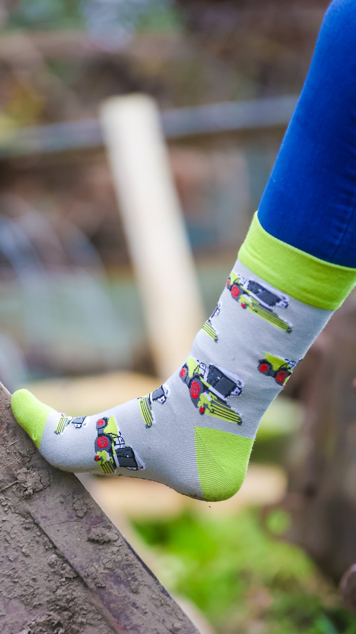 Unisex farm style forager socks, showcasing a grey background embellished with vibrant green foragers, featuring matching green tops, heels, and toe.