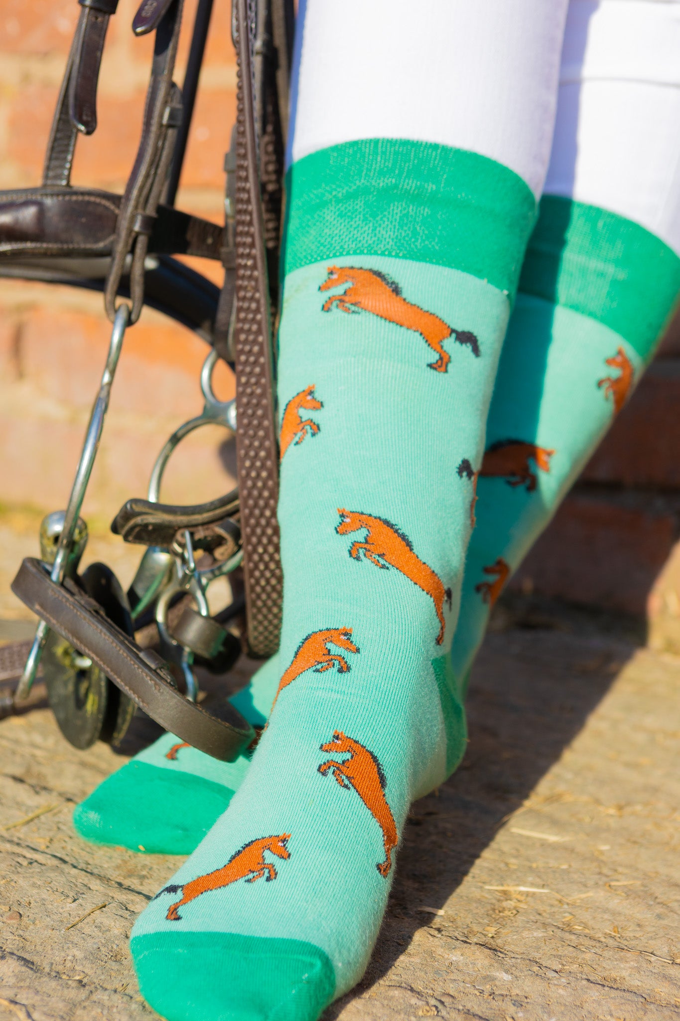 Brown horse socks. These cosy crew socks have bay/brown rearing horses on a light green background and contrasting green top, heel and toe.