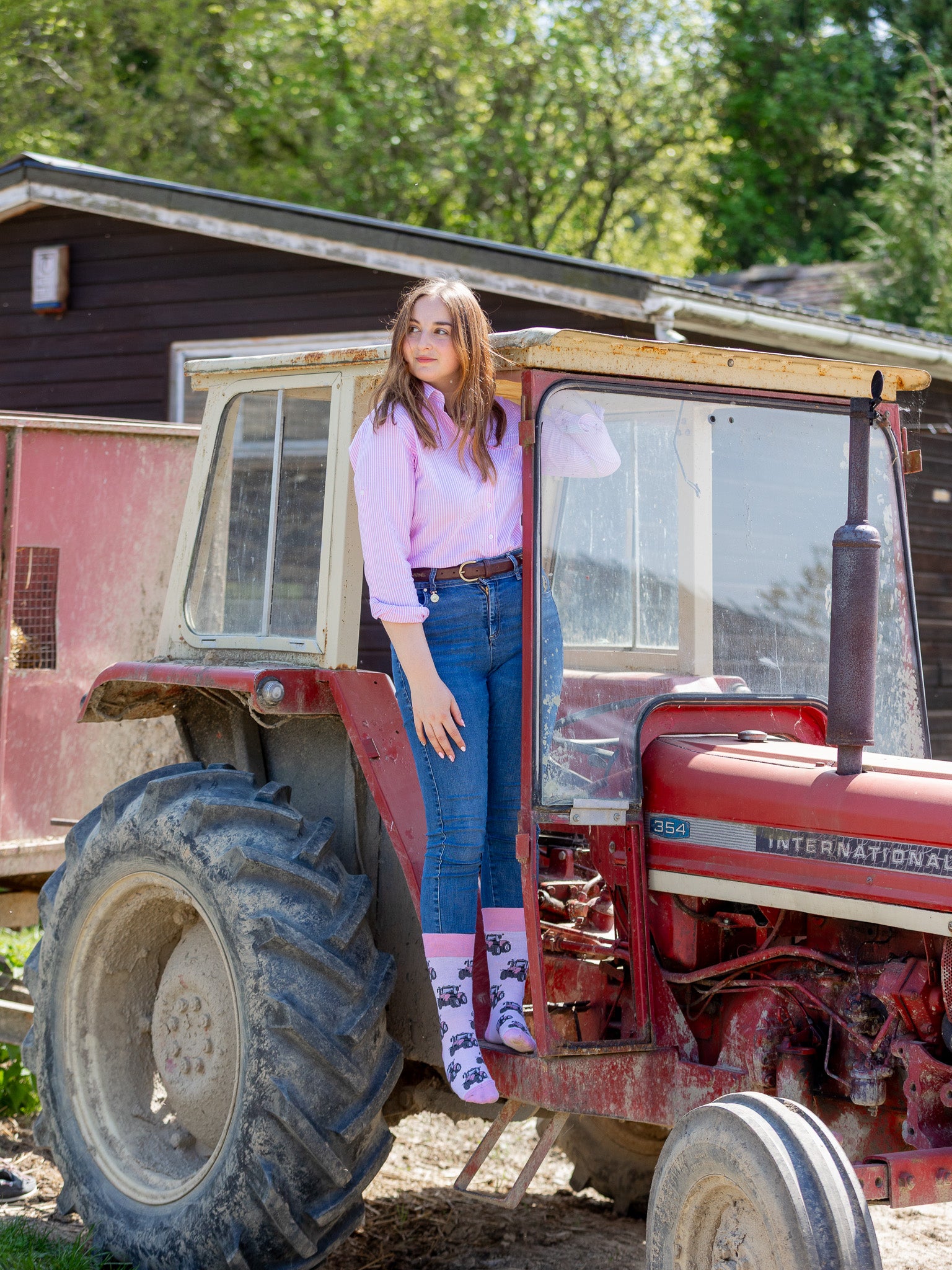 Unique pink tractor socks. These cosy crew socks have vibrant pink tractors on a light pink background and vibrant pink top, heel and toe.