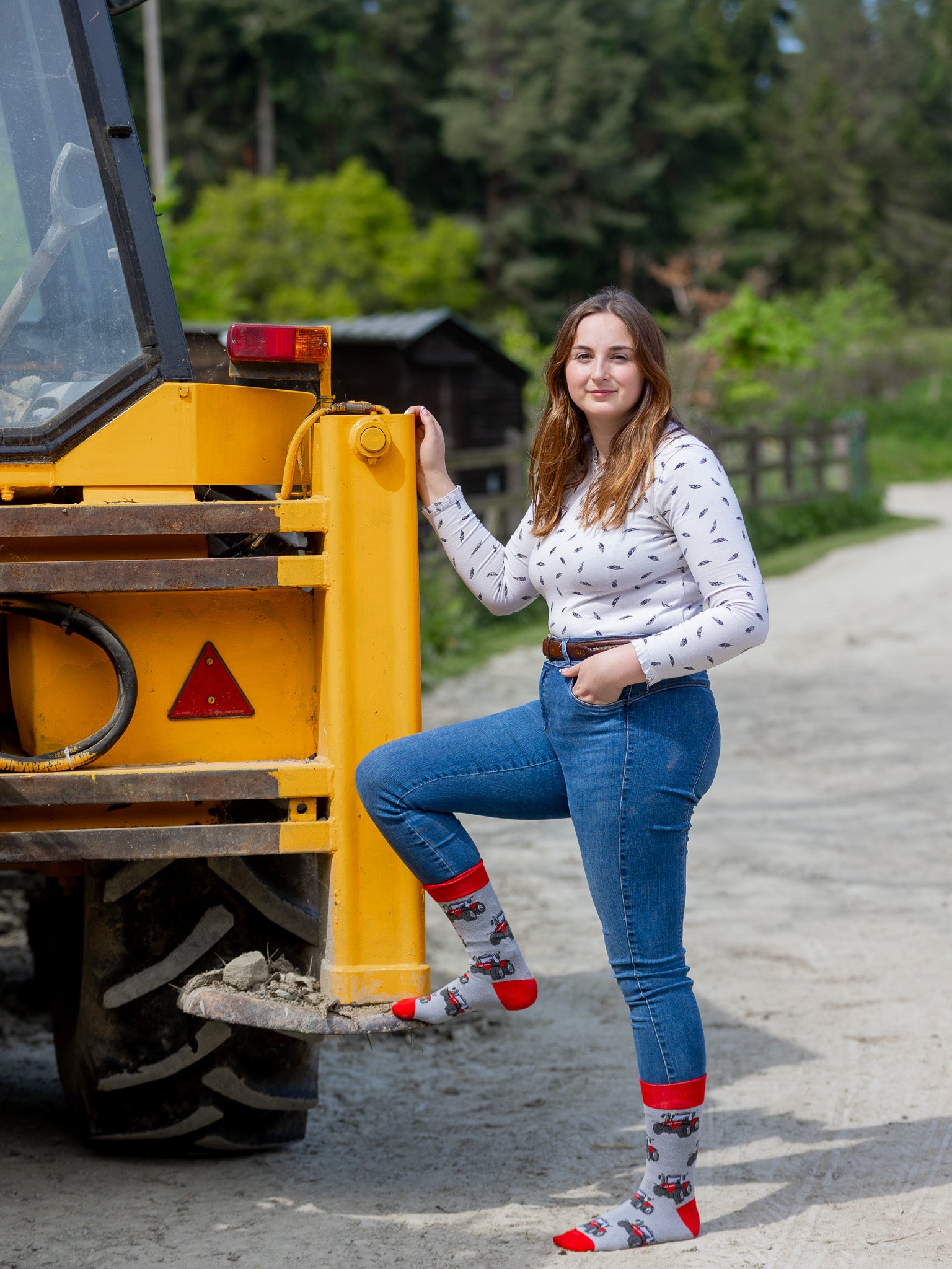 A unique red tractor design. These cosy crew socks are sporting vibrant red tractors on a light grey background and same colour red top, heel and toe.
