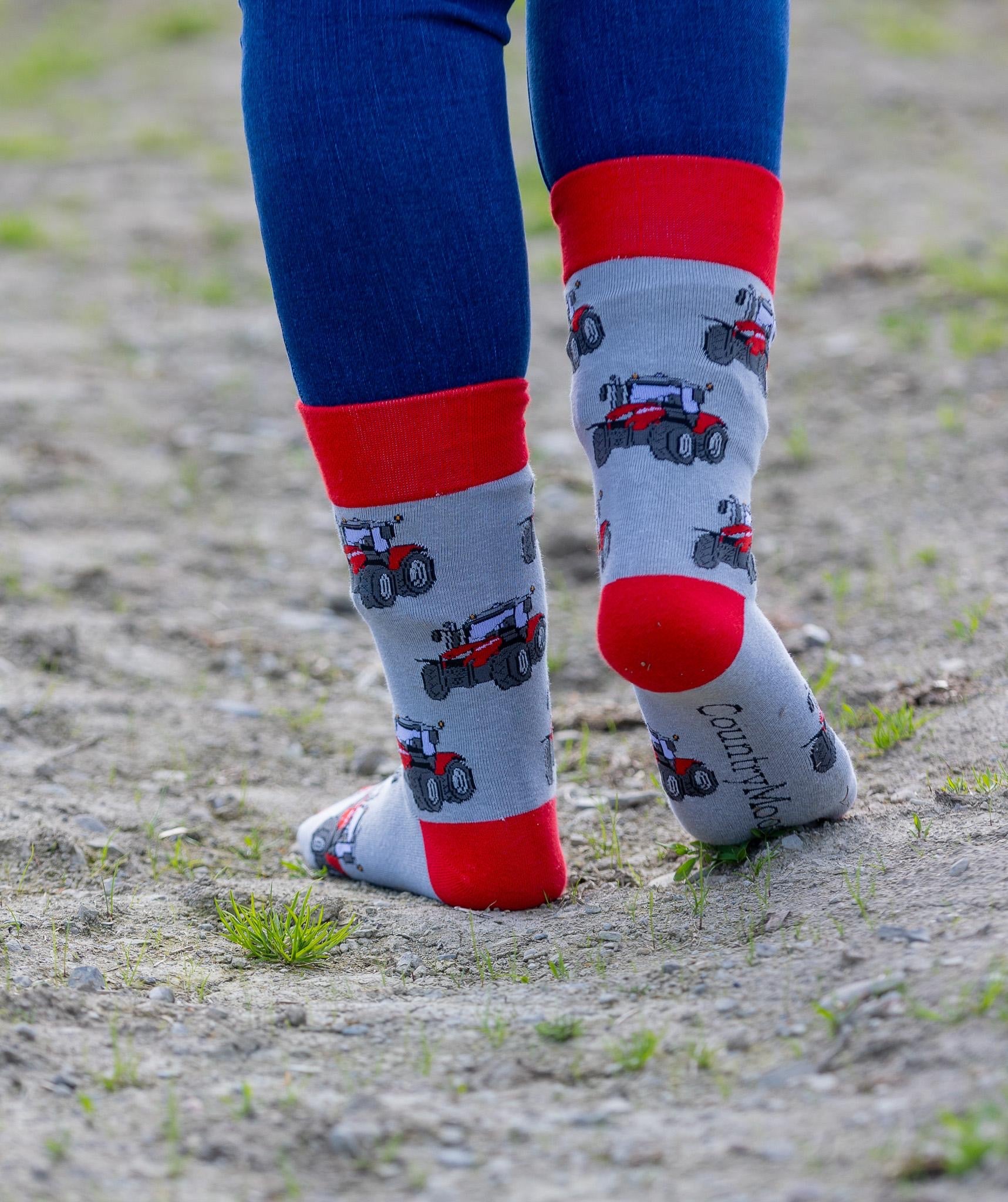 Unisex red tractor socks. These crew socks have vibrant red tractors on a light grey background with matching red top, heel and toe.