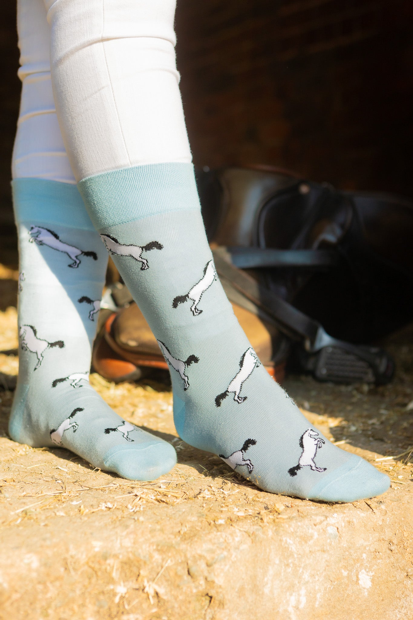 Unique horse socks. A unisex designs these cosy crew socks sport grey rearing horses on a light blue background and a darker blue top, heel and toe.