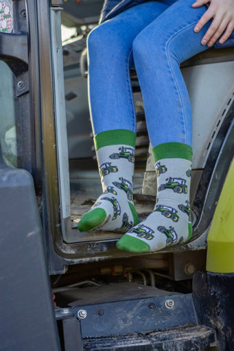 Green country-style tractor socks featuring a modern tractor design on a grey background, accented with a matching green top, heel, and toe. These cozy and stylish socks are perfect for farmers and tractor enthusiasts who love the countryside, offering both comfort and a touch of country charm for everyday wear.