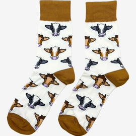 Mix cow socks featuring a cream background with charming brown top heel and toe accents and brown, black and grey cows. Perfect for adding a gracious touch to your footwear collection. Ideal for casual wear, these cozy, stylish cow socks celebrate country farm living and ensure comfort for all occasions.