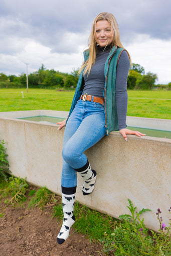 Belted Galloway cow socks designed with charming black and white Belted Galloway illustrations on a light cream background, complemented by black accents on the top, heel, and toe. These cozy socks are perfect for cow  and countryside enthusiasts, offering a elegant touch to any country farm inspired outfit.