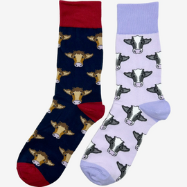 2 pairs of crew socks featuring a purple cow design on a light purple background, showcasing elegant black and brown cows with an elegant purple top, heel, and toe. Also included are navy red socks, set against a navy backdrop adorned with playful brown cows, complemented by royal red tops, heels, and toes. Perfect gifts for countryside enthusiasts, outdoor lovers and farming people, these cozy socks bring a touch of country style and comfort.