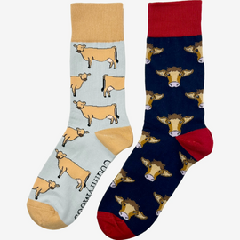 2 pairs of crew socks featuring a navy red cow design on a navy background, showcasing elegant brown cows with an elegant royal red top, heel, and toe. Also included are jersey socks, set against a light brown backdrop adorned with playful brown cows, complemented by brown tops, heels, and toes. Perfect gifts for countryside enthusiasts, outdoor lovers and farming people, these cozy socks bring a touch of country style and comfort.