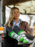 Green tractor crew socks. These unisex tractor socks sport green tractors on a light grey background with a matching green top, heel and toe. 