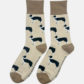 "These charming collie dog farm socks feature a black and white collie design on a light brown background, accented by rich brown heel and toe. Perfect for completing a country outfit, they add rustic flair and comfort for long walks in the countryside. Embrace your love for rural life and your furry friends with these stylish and cozy socks!"