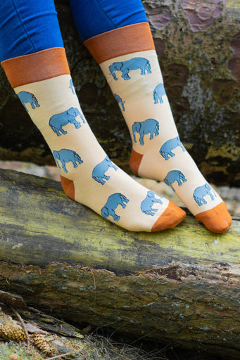 Charming elephant socks featuring adorable elephant designs on a lovely light peach background, complemented by burnt orange tops, heels, and toes. These trendy socks are perfect for animal lovers and add a playful touch to your everyday outfits. Ideal for comfort and style, these socks make a wonderful addition to any wardrobe, bringing a pop of color and fun to your sock collection