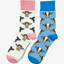 Country style blue striped socks on a white background featuring charming brown cows, paired with vibrant and fun pink cow socks which feature brown and black cows on a gracious cream background with light pink top heel and toe. These delightful designs capture the essence of farm life, making them perfect for outdoor enthusiasts and rural fashion lovers alike. The perfect gift to anyone who loves animals and countryside style.