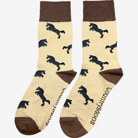 Elegant brown-themed horse socks featuring a stylish design of black horses on a light brown background. The socks are accented with a more vibrant brown top, heel, and toe for added sophistication. Perfect for equestrian enthusiasts and horse lovers, these comfortable socks combine practicality with a chic country aesthetic, making them a great addition to any wardrobe and a lovely gift for those who appreciate the beauty of horses.