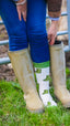 Welly socks featuring a playful design of green wellington boots on a cream background, with coordinating green accents on the top, heel, and toe. These comfortable and stylish country socks are perfect for rainy days and outdoor adventures, adding a touch of fun to your footwear while keeping your feet warm and cozy.