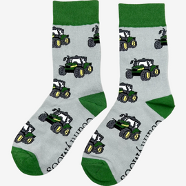 Adorable children's green tractor socks featuring playful green tractors against a stylish grey background, complete with matching green tops, heels, and toes. These fun and comfortable socks are perfect for young farm enthusiasts and add a touch of countryside charm to any outfit