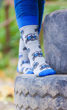 Blue country-style tractor socks featuring a modern tractor design on a grey background, accented with a matching blue top, heel, and toe. These cozy and stylish socks are perfect for farmers and tractor enthusiasts who love the countryside, offering both comfort and a touch of country charm for everyday wear.