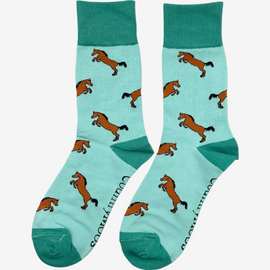 Elegant green-themed horse socks featuring stunning bay horses against a mild green background. These stylish socks are adorned with a darker green top, heel, and toe, creating a sophisticated look that appeals to equestrians and horse lovers alike. Perfect for adding a touch of countryside elegance to your wardrobe, these socks make a great gift for those who appreciate the beauty of horses and the outdoors