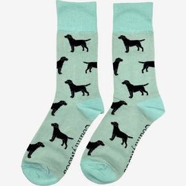 Adorable black Labrador socks set against a lovely light mint green background, designed for dog lovers and fans of countryside fashion. These cozy socks feature playful Labrador motifs, making them a perfect accessory for any casual outfit. Ideal for those who appreciate a touch of whimsy and comfort, these socks celebrate the bond between dogs and their owners while enhancing your country-inspired wardrobe