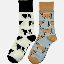 2 pairs of crew socks featuring jersey cow design on a light grey background, showcasing elegant brown cows with an vibrantly elegant brown top, heel, and toe. Also included are belted Galloway socks, set against a light cream backdrop adorned with playful black and white cows, complemented by black tops, heels, and toes. Perfect gifts for countryside enthusiasts, outdoor lovers and farming people, these cozy socks bring a touch of country style and comfort.