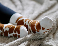 Cozy country style fluffy socks featuring a striking brown and white cow print design. These socks are perfect for adding a fun, rustic touch to your wardrobe while providing ultimate comfort. Ideal for cow lovers and anyone who appreciates a playful yet stylish accessory, these socks are a must-have for lounging or outdoor adventures