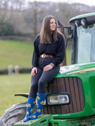 Crew socks for people who love cows. These cow socks have yellow cow tags saying cows 365 on a dark blue background and a lighter blue top, heel and toe. 