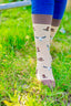 Western country style socks featuring playful cowboy hats and cow boots on a rich brown background, with a darker brown accent on the top, heel, and toe. These stylish and comfortable socks are perfect for cowboys and country lovers alike, adding a fun, rustic flair to your country wardrobe while embodying the spirit.