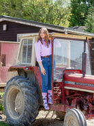 Unique pink tractor socks. These cosy crew socks have vibrant pink tractors on a light pink background and vibrant pink top, heel and toe. 