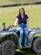 Unisex crew socks with pigs on, sporting a mixture of brown and black pigs on a bright sky blue background and brown top, heel and toe.