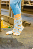 Jersey cow socks featuring adorable Jersey cow illustrations on a light brown background, with a slightly darker brown accent on the top, heel, and toe. These comfy country and stylish country style socks are perfect for cow and animal fans, adding a fun and unique touch to your outfit while celebrating the countryside and the outdoors.