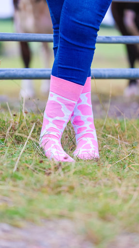 "Step into style with our charming pink cow print socks, perfect for adding a fun, farm-themed twist to your outfits! Inspired by the whimsical spirit of the countryside, these cozy socks are designed for ultimate comfort while keeping your look playful and trendy. Ideal for both farm adventures and cozy nights in, these socks will surely become your new favorite accessory. Embrace the farm vibe and elevate your sock game.