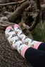 Pink cow socks featuring adorable cow designs on a soft cream background, complemented by a coordinating pink top, heel, and toe. These charming socks combine playful aesthetics with comfortable wear, making them a perfect accessory for cow enthusiasts and anyone looking to add a touch of elegance to their country outfit.