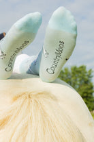 Unisex horse socks. These unique cosy crew socks sport grey rearing horses on a light blue background and darker blue top, heel and toe. 