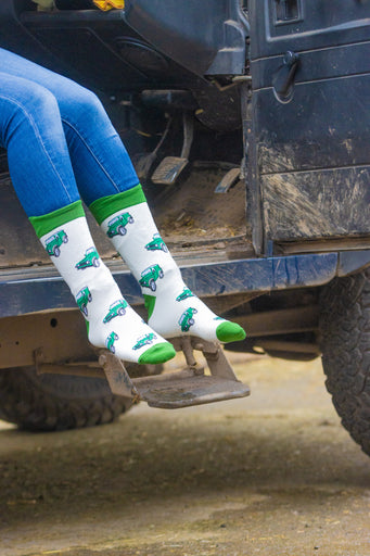 Land Rover socks showcasing a charming pattern of Land Rover vehicles on a cream background, complemented by matching green accents on the top, heel, and toe. These stylish country and comfortable socks are perfect for outdoor enthusiasts and Land Rover fans, adding a rugged touch to any outfit while ensuring all-day comfort.