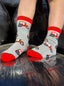 Adorable children's red tractor socks featuring playful red tractors against a stylish grey background, complete with matching red tops, heels, and toes. These fun and comfortable socks are perfect for young farm enthusiasts and add a touch of countryside charm to any outfit