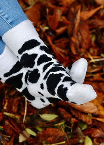 Cozy country style fluffy socks featuring a striking black and white cow print design. These socks are perfect for adding a fun, rustic touch to your wardrobe while providing ultimate comfort. Ideal for cow lovers and anyone who appreciates a playful yet stylish accessory, these socks are a must-have for lounging or outdoor adventures