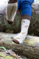 Stylish giraffe socks featuring a charming design on a lovely light beige background, complemented by dark brown tops, heels, and toes. These playful socks are perfect for animal lovers and fashion enthusiasts alike, offering a unique touch to any outfit. Ideal for casual wear or gifts, they blend comfort with a fun, safari-inspired theme