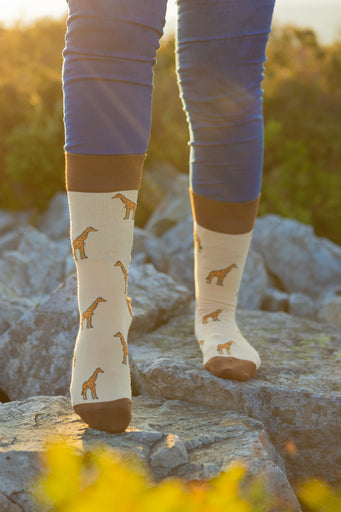 Stylish giraffe socks featuring a charming design on a lovely light beige background, complemented by dark brown tops, heels, and toes. These playful socks are perfect for animal lovers and fashion enthusiasts alike, offering a unique touch to any outfit. Ideal for casual wear or gifts, they blend comfort with a fun, safari-inspired theme