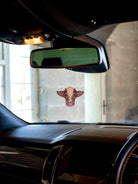 Brown cow air freshener with the scent of rainforest. Double sided print with hang string and safety instructions on the back. 