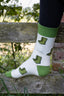 Welly socks featuring a playful design of green wellington boots on a cream background, with coordinating green accents on the top, heel, and toe. These comfortable and stylish country socks are perfect for rainy days and outdoor adventures, adding a touch of fun to your footwear while keeping your feet warm and cozy.