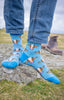 Blue striped cow socks showcasing a playful design on a white background, featuring vibrant blue stripes and cute brown cows. Perfect for adding a fun and cozy touch to your outfit, these socks are ideal for casual wear and a great way to embrace farm and country charm.