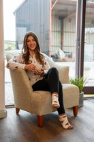 Country girl sat having tea wearing highland cow ankle socks 