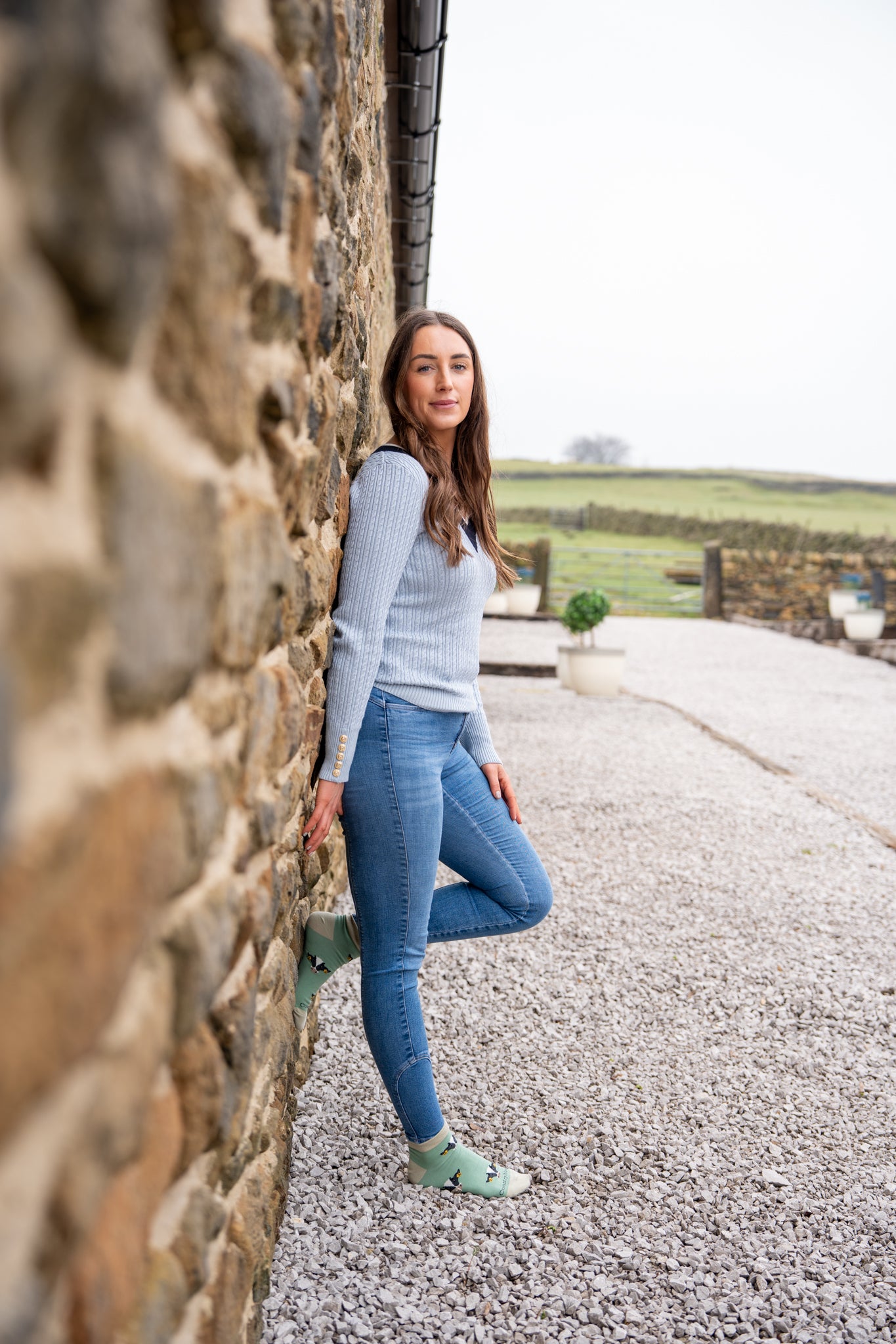 Country girl stood modelling green cow ankle socks 
