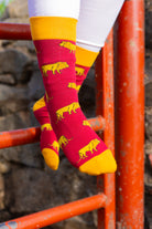 Bold lion socks featuring a striking bright red background adorned with playful lion graphics, complemented by bright yellow tops, heels, and toes. These eye-catching socks are perfect for animal lovers and those seeking to make a statement with their footwear. Ideal for adding a fun and vibrant touch to any outfit while ensuring comfort and style