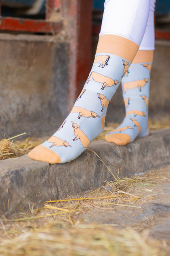 Jersey cow socks featuring adorable Jersey cow illustrations on a light brown background, with a slightly darker brown accent on the top, heel, and toe. These comfy country and stylish country style socks are perfect for cow and animal fans, adding a fun and unique touch to your outfit while celebrating the countryside and the outdoors.