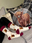 Elegant highland cow socks set against a cream background, adorned with charming brown top heel and toe accents and playful polka dots. Featuring delightful Highland cows, these cozy socks are perfect for adding a touch to your country style wardrobe while ensuring comfort for everyday wear.