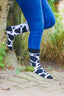 Black and white cow print socks showcasing a fun and trendy design inspired by classic cow patterns. Perfect for animal lovers, these stylish socks combine comfort and flair, making them ideal for everyday wear or adding a unique touch to your country outfit. Elevate your sock game with these chic cow print socks.