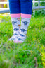 Pink cow socks featuring adorable cow designs on a soft cream background, complemented by a coordinating pink top, heel, and toe. These charming socks combine playful aesthetics with comfortable wear, making them a perfect accessory for cow enthusiasts and anyone looking to add a touch of elegance to their country outfit.