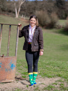 Unisex dairy cow crew socks, with cows, milk bottles, tags and overalls on a bright green background and yellow top, heel and toe.