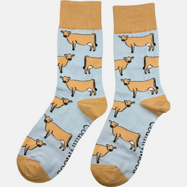 Jersey cow socks featuring adorable Jersey cow illustrations on a light brown background, with a slightly darker brown accent on the top, heel, and toe. These comfy country and stylish country style socks are perfect for cow and animal fans, adding a fun and unique touch to your outfit while celebrating the countryside and the outdoors.