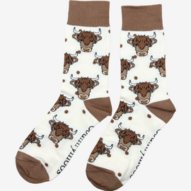 Elegant highland cow socks set against a cream background, adorned with charming brown top heel and toe accents and playful polka dots. Featuring delightful Highland cows, these cozy socks are perfect for adding a touch to your country style wardrobe while ensuring comfort for everyday wear.